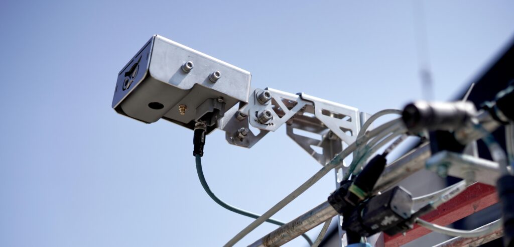 OWL mounted to a spray boom with the stainless steel OWL mount